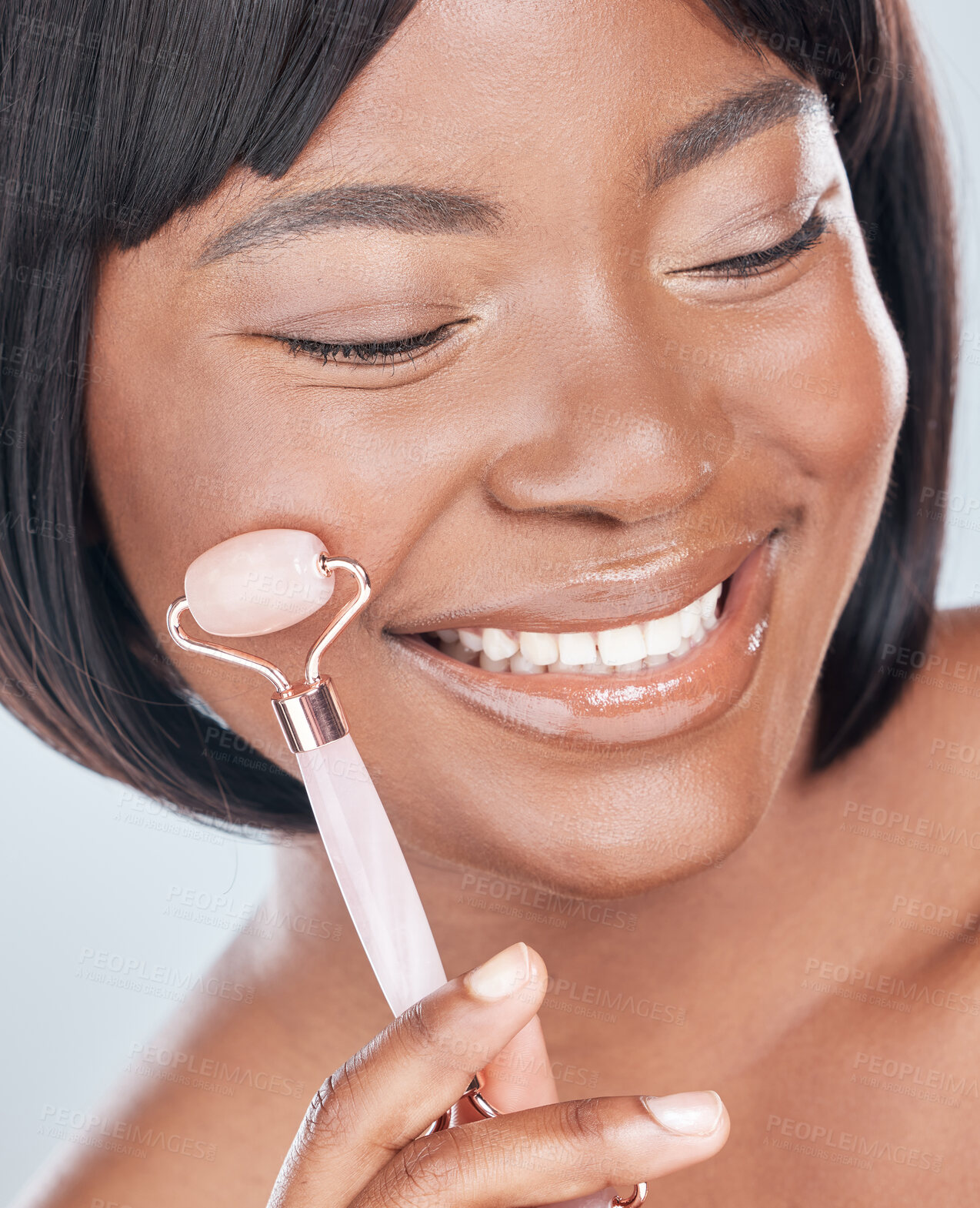 Buy stock photo Skincare, derma roller and happy black woman in studio with wellness, cosmetics or anti aging treatment. Rolling skin, face and African beauty model with stone, crystal or lymphatic facial massage