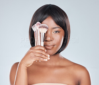 Buy stock photo Black woman, makeup brush and cover eye in studio with change, beauty and foundation by background. Girl, person and glow with tools, cosmetics and product for facial skin with results for aesthetic