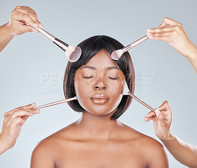 Buy stock photo Studio shot of an attractive young woman having makeup applied to her face against a grey background