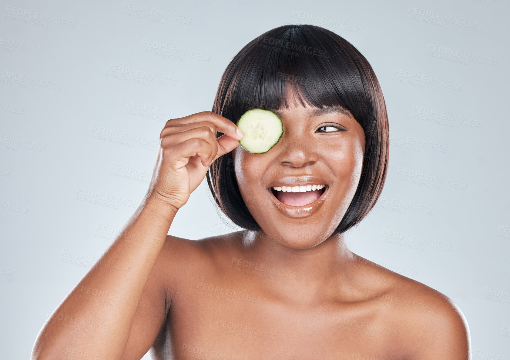 Buy stock photo Skincare, smile and happy black woman with cucumber In studio for wellness, shine or dermatology on grey background. Organic, face and model with eco friendly, sustainable or vegan beauty treatment