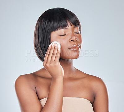 Buy stock photo Cotton pad, beauty and black woman with cosmetics, skincare and dermatology in studio. Wellness, youth serum and face cleaning with facial, skin glow and care with swab and shine from treatment