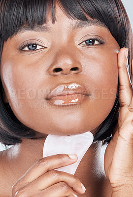 Buy stock photo Studio shot of an attractive young woman using a beauty patch against a grey background