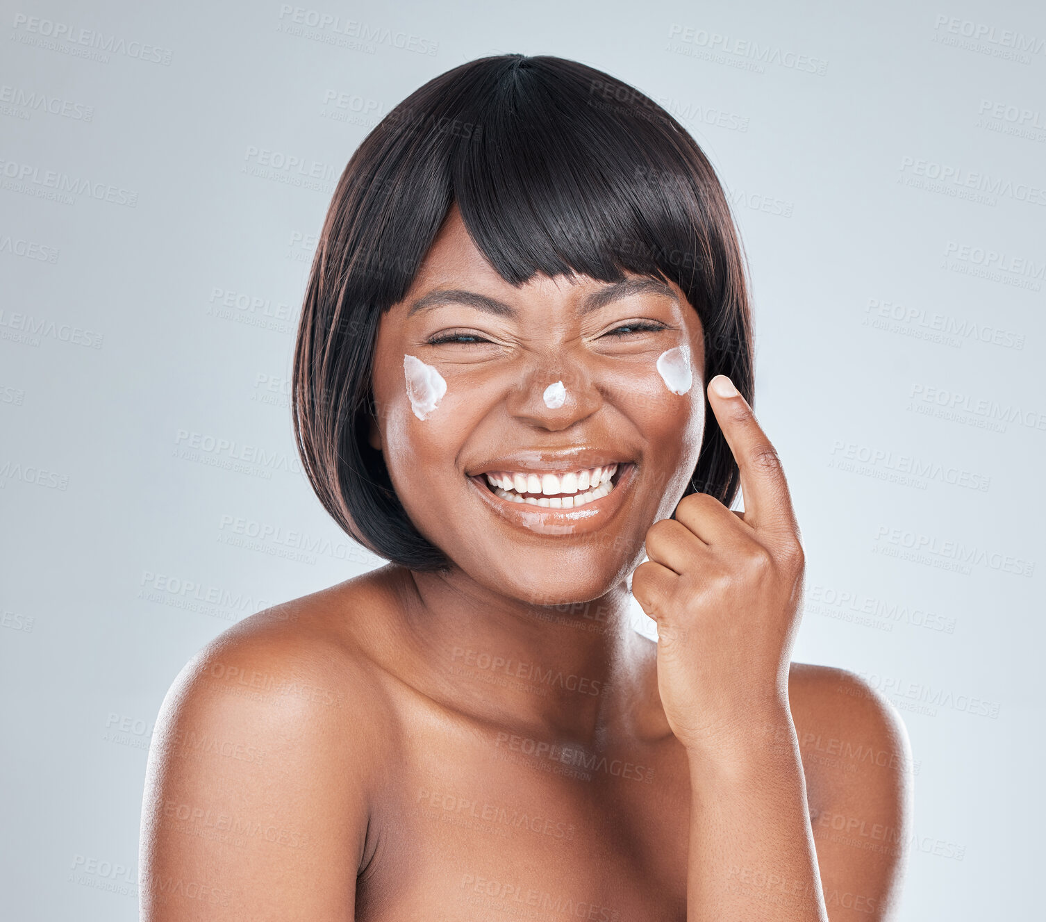 Buy stock photo Excited, portrait and black woman with cream for skincare, facial treatment or moisturizer on a white studio background. Young African or female person with smile, lotion or cosmetics on healthy skin