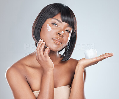 Buy stock photo Skincare, palm space and black woman with face cream application in studio for wellness, shine or cosmetics on grey background. Beauty, sunscreen or portrait with anti aging, lotion or collagen promo