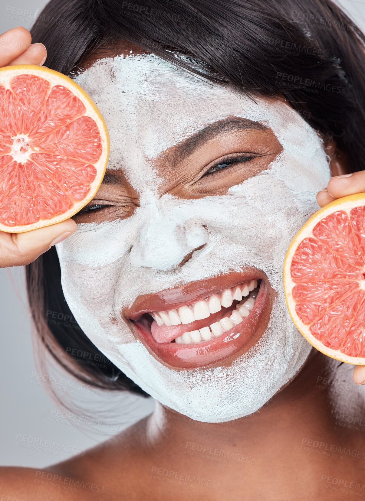 Buy stock photo Grapefruit, facial mask and portrait of black woman for beauty, skincare or wellness closeup in studio. Face, fruit and funny model with tongue out for organic food, healthy diet or natural cosmetics