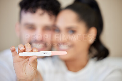 Buy stock photo Closeup shot of a young couple looking happy with a negative pregnancy test result at home