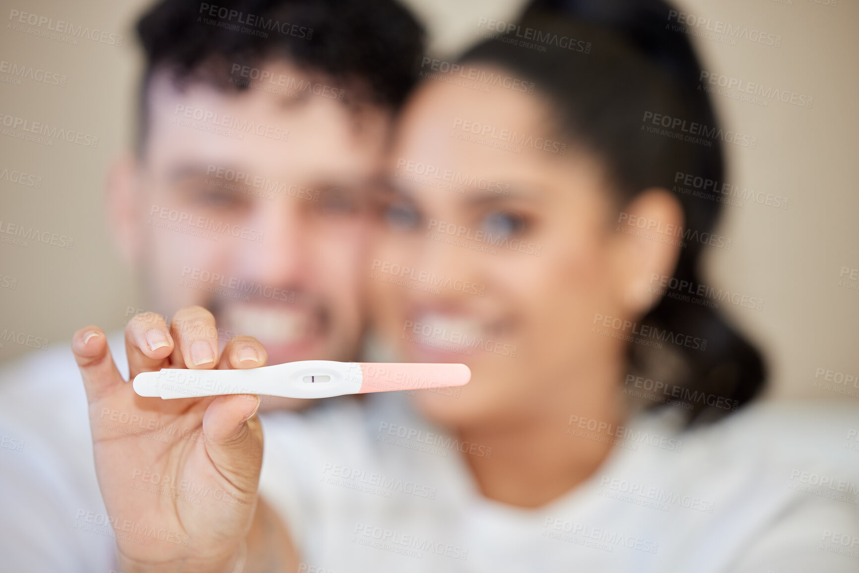 Buy stock photo Closeup shot of a young couple looking happy with a negative pregnancy test result at home