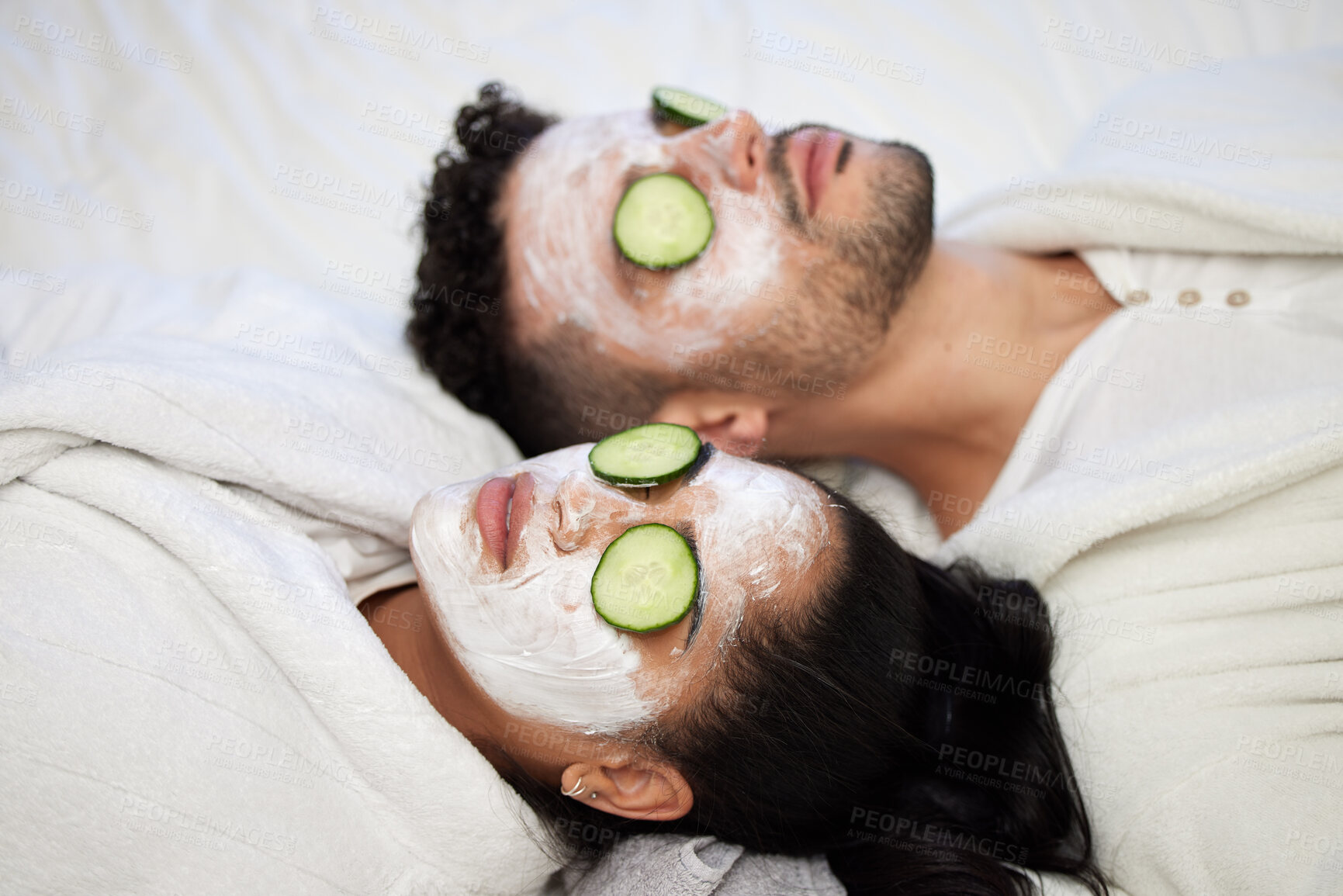 Buy stock photo Facial, spa and relax with couple and mask for skincare, cosmetics and detox treatment. Beauty, face and self care weekend with man and woman in bedroom at home for salon, wellness and cucumber