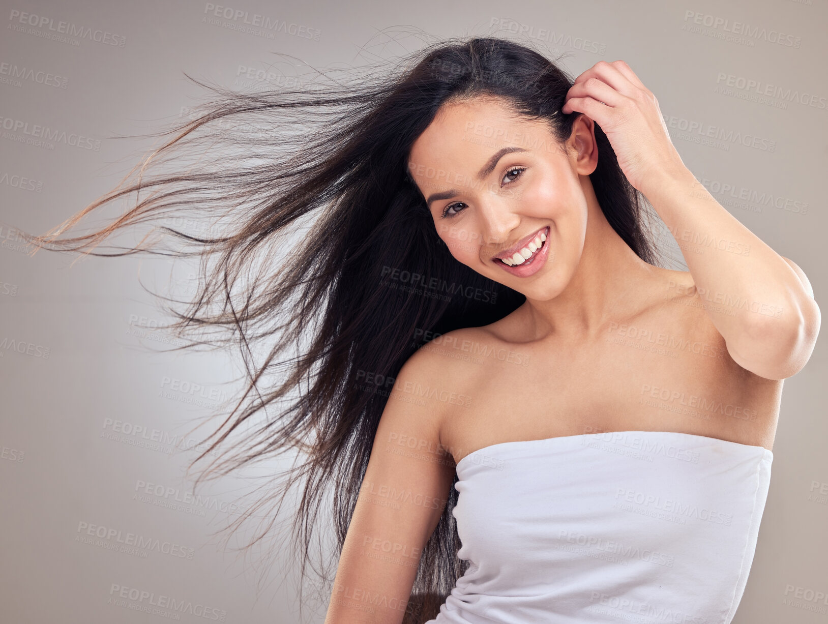 Buy stock photo Wind, portrait and haircare for woman with smile, healthy and promotion of hair, results and confidence. Studio background, salon treatment and growth for girl, hairstyle and proud of routine in USA