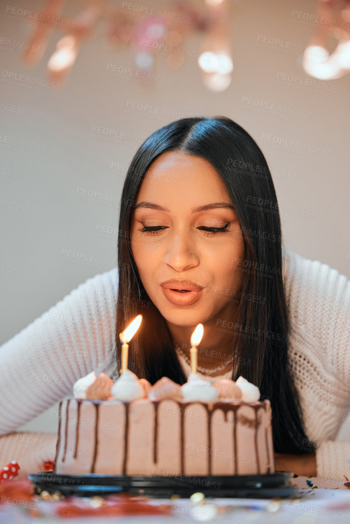 Buy stock photo Birthday, candles and woman blow cake at party for celebration, surprise and present. Happy, flame and young female person with dessert food, sweet treat and fire for special event at apartment.