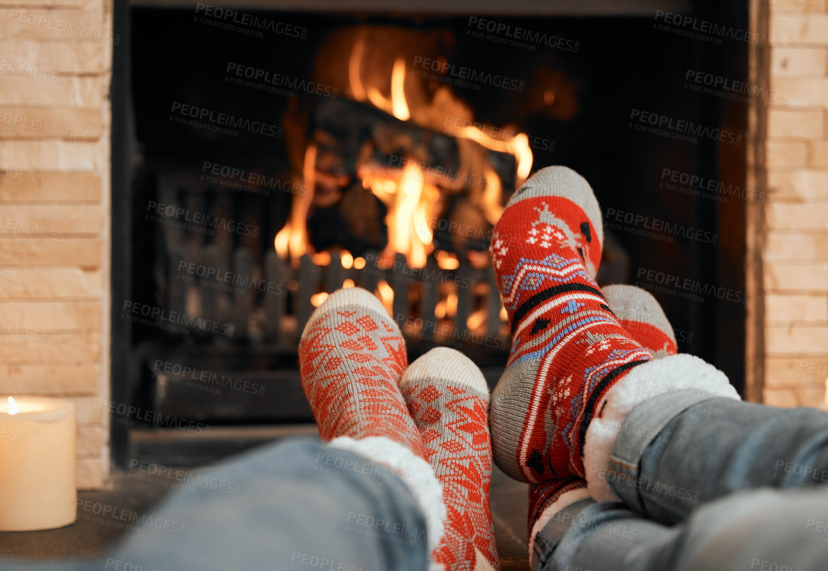 Buy stock photo Couple, Christmas and socks by fireplace for celebration to relax at house, romantic and bonding on holiday in winter. People, legs and warm for home, together and love for comfort, wool and heat