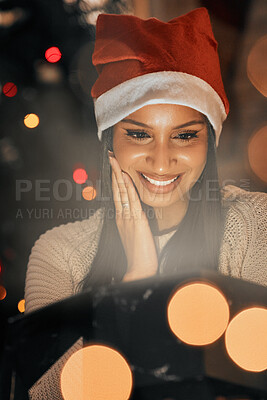 Buy stock photo Celebration, relax and black woman with smile in Christmas, bokeh and memory for festive, holiday and hat on vacation. Home, peace and happiness of girl with tree, lounge and thinking in apartment