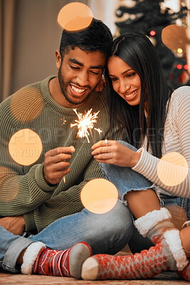 Buy stock photo Couple, people and happy in home with sparklers for Christmas, festive and holiday celebration. Relationship, love and smile for bonding with firework in winter for joy, fun and tradition as soulmate