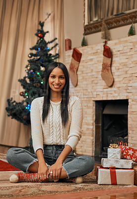 Buy stock photo Relax, portrait and black woman with smile in Christmas, celebration and gift for festive, holiday and floor on vacation. Home, peace and happiness of girl with tree, lounge and present in apartment