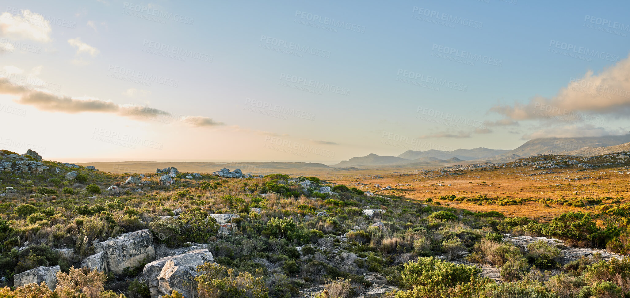 Buy stock photo Hill, landscape and countryside with field, rocks and clouds in spring for space in sky on horizon. Outdoor, nature and stone in environment with outcrop, shrub or bush on savanna at national park