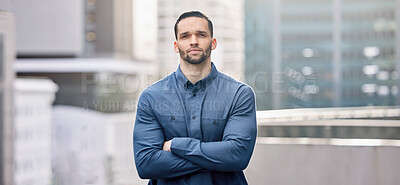 Buy stock photo Shot of a young businessman standing against a city background