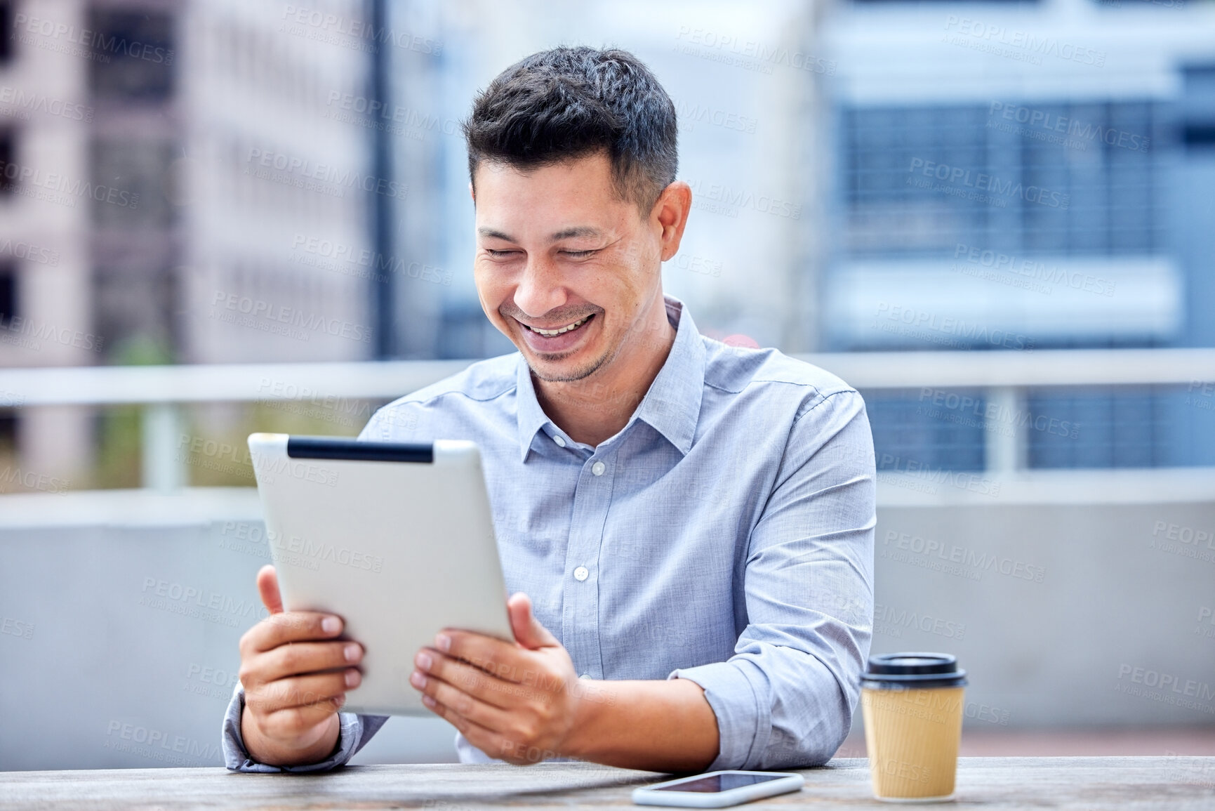 Buy stock photo Shot of a young businessman using a digital tablet at work