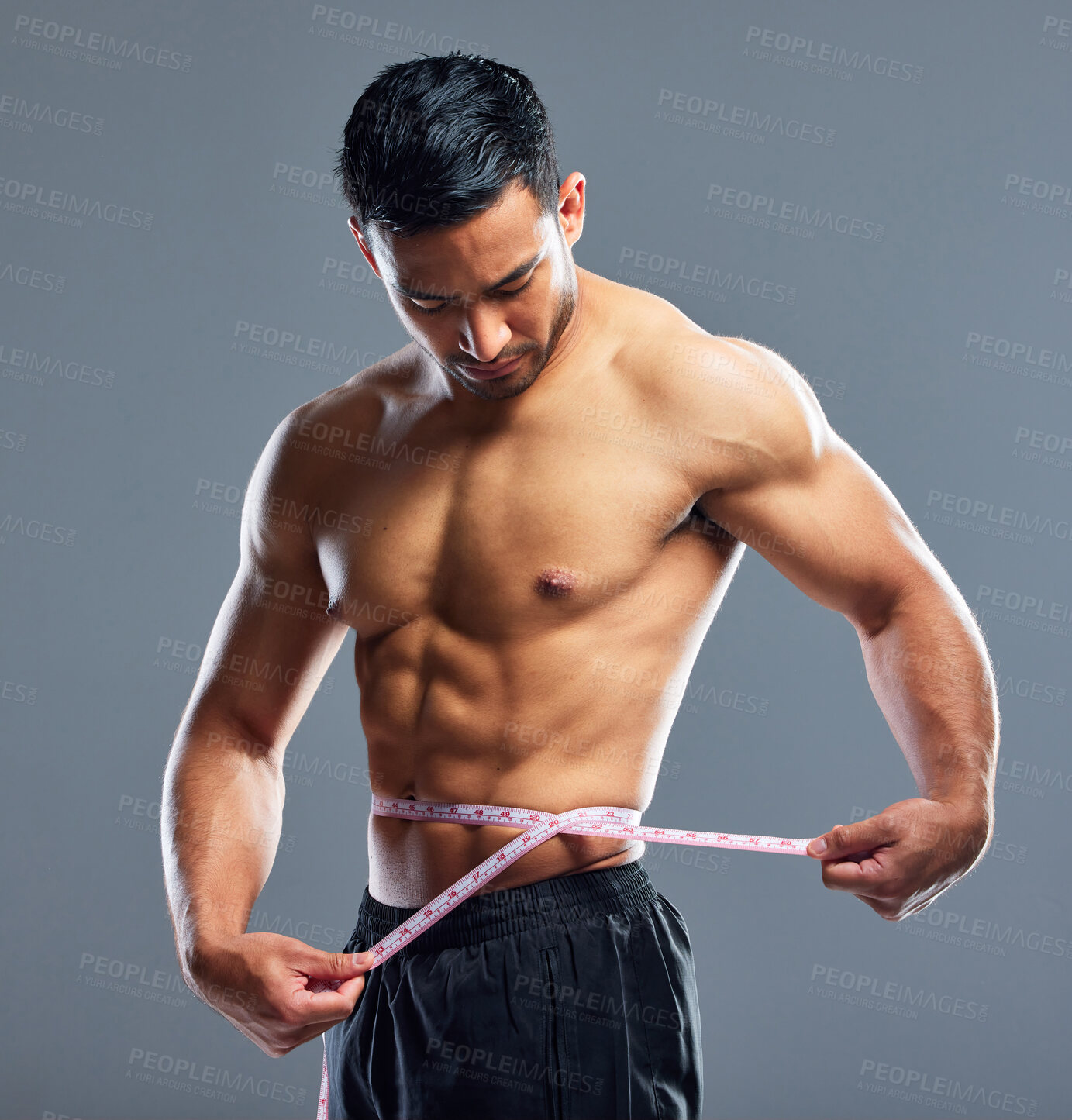 Buy stock photo Man, body and measurement for waist, weight loss and management for fat control or bmi and diet wellness. Fitness model, sports athlete or guy with tape measure for muscle goals on studio background