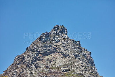 Buy stock photo Low angle of a mountain peak isolated against a clear blue sky in South Africa for copy space background. Scenic and quiet mountaintop and rocky landscape view of a remote location on a sunny day