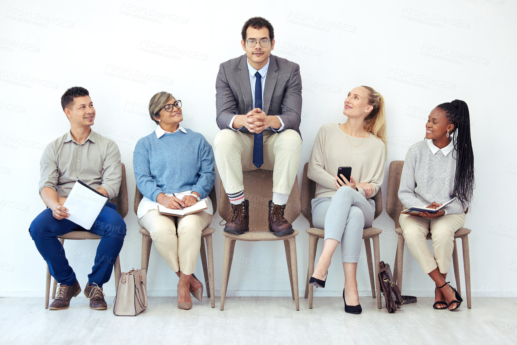 Buy stock photo Businessman, people and waiting room with group for interview, career or job at office. Young man or employee with interns on chair in row to stand out for business opportunity, selection or choice