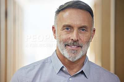 Buy stock photo Cropped portrait of a handsome mature businessman standing in his office