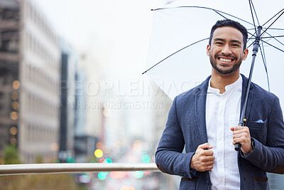 Buy stock photo Cropped portrait of a handsome young businessman standing outside with an umbrella in the city