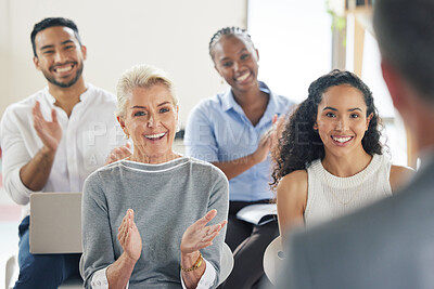 Buy stock photo Shot of a group of business people applauding during a presentation