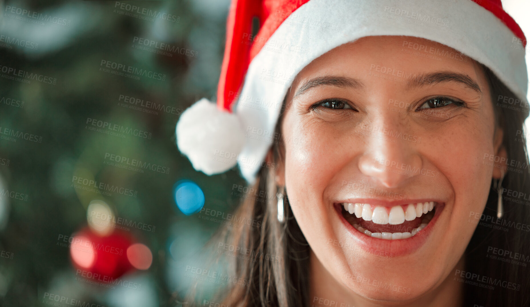 Buy stock photo Shot of a young woman celebrating Christmas at home