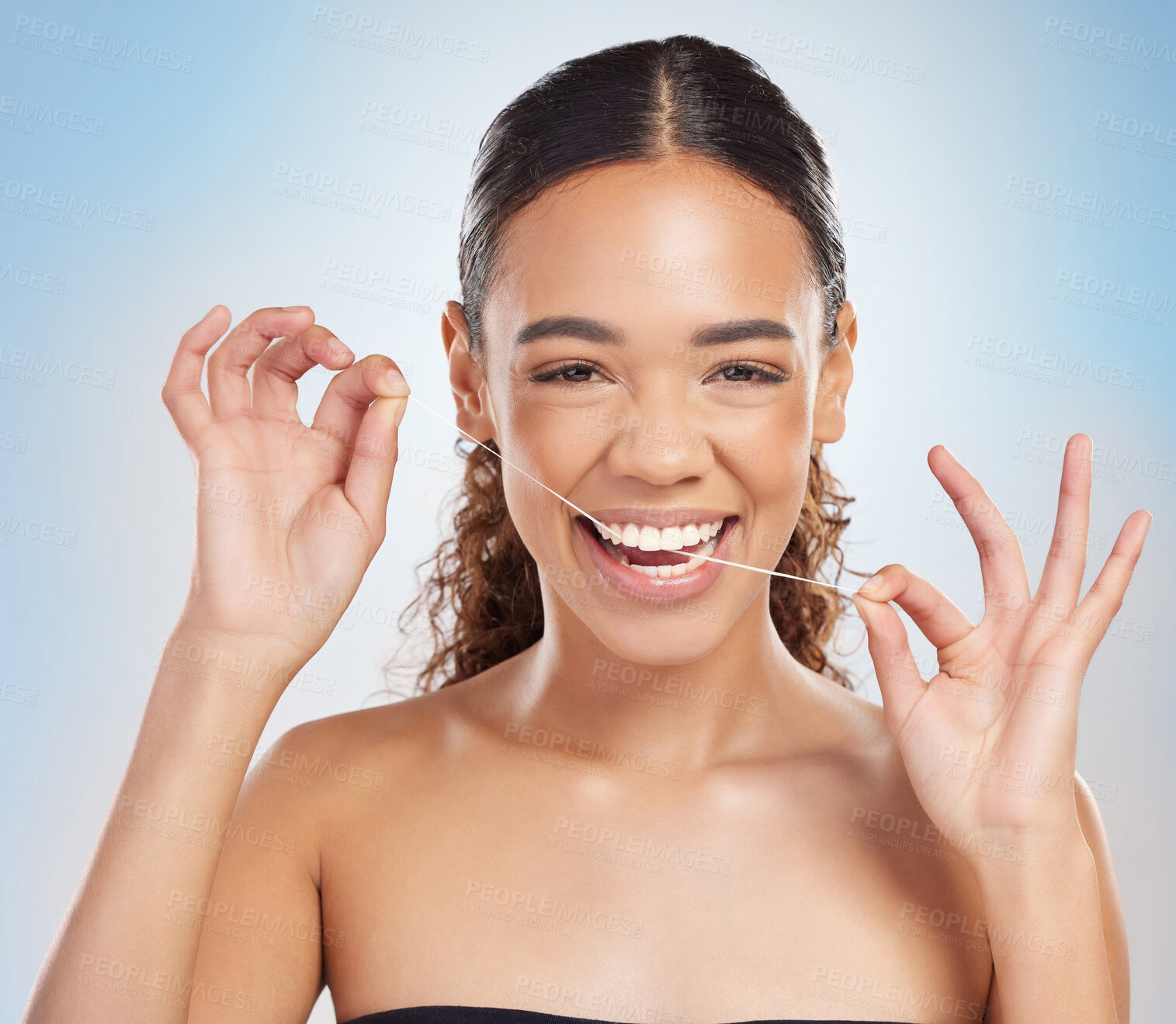 Buy stock photo Woman, portrait and flossing teeth for healthy gums on studio blue background, hygiene or dentist. Female person, face with hands for smile self care or morning routine for oral, cleaning or mouth