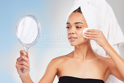 Buy stock photo Shot of a young woman looking in a mirror against a blue background