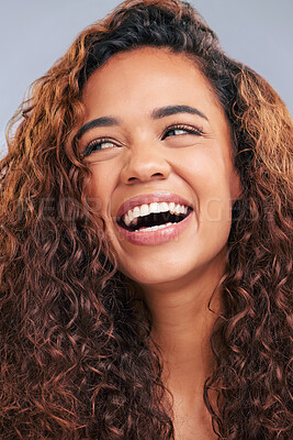 Buy stock photo Laughing, curly hair and natural woman in studio with smile and face glow. Happy female person with beauty and healthy curls as benefits or results of shampoo or cosmetics on a grey background