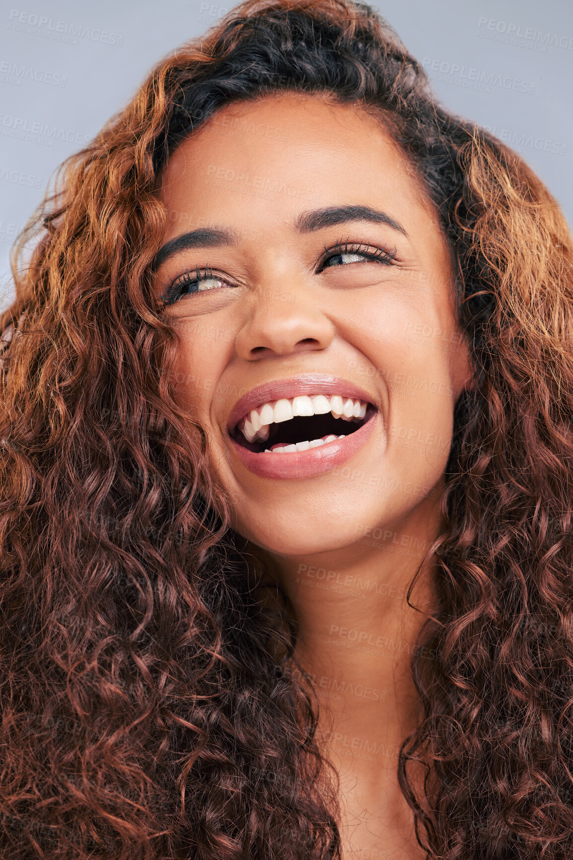 Buy stock photo Laughing, curly hair and natural woman in studio with smile and face glow. Happy female person with beauty and healthy curls as benefits or results of shampoo or cosmetics on a grey background