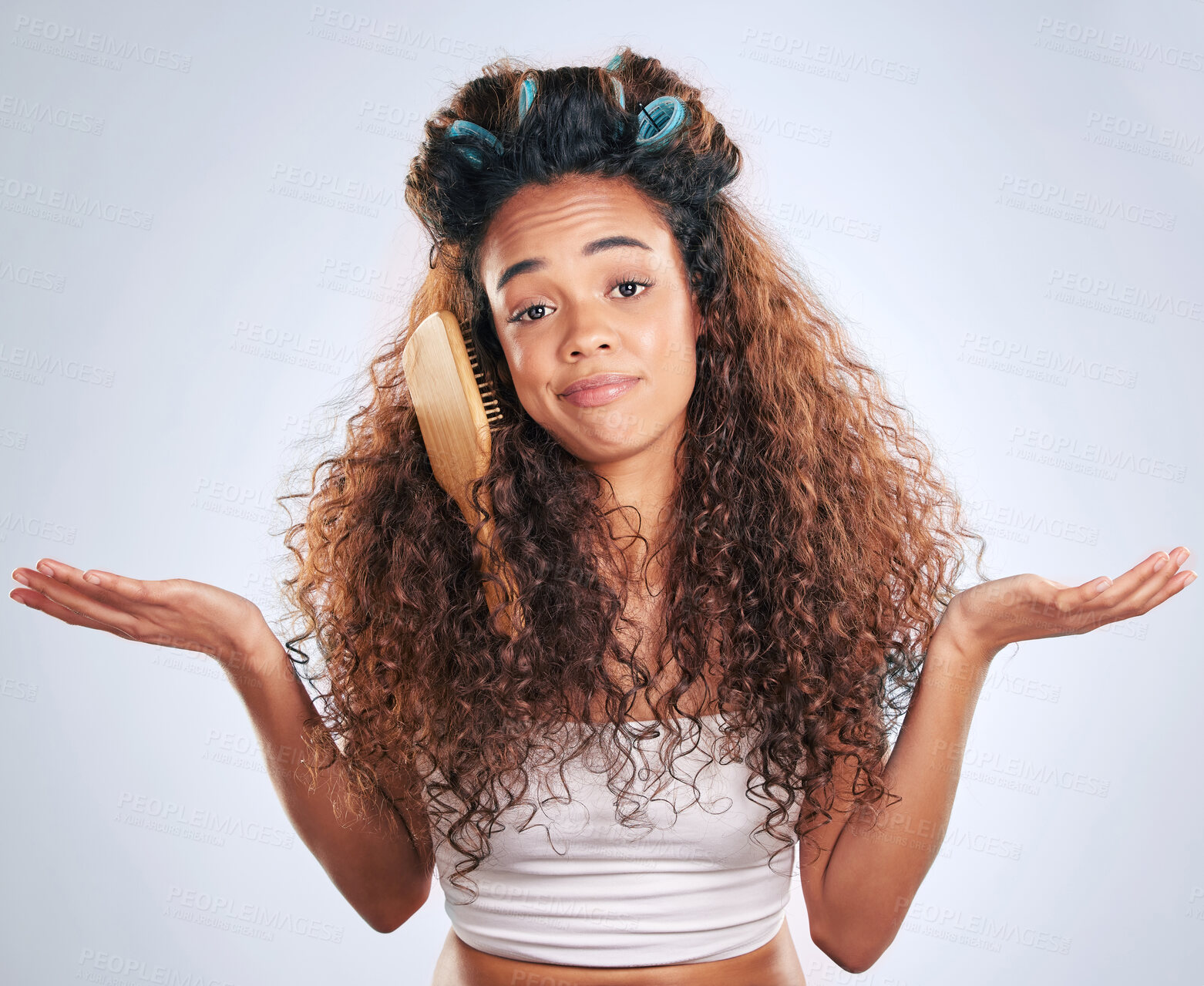 Buy stock photo Beauty, shrug and woman with brush in hair on studio gray background for haircare frustration. Curly, face or fed up and unhappy African model in bathroom with morning routine or haircare problems