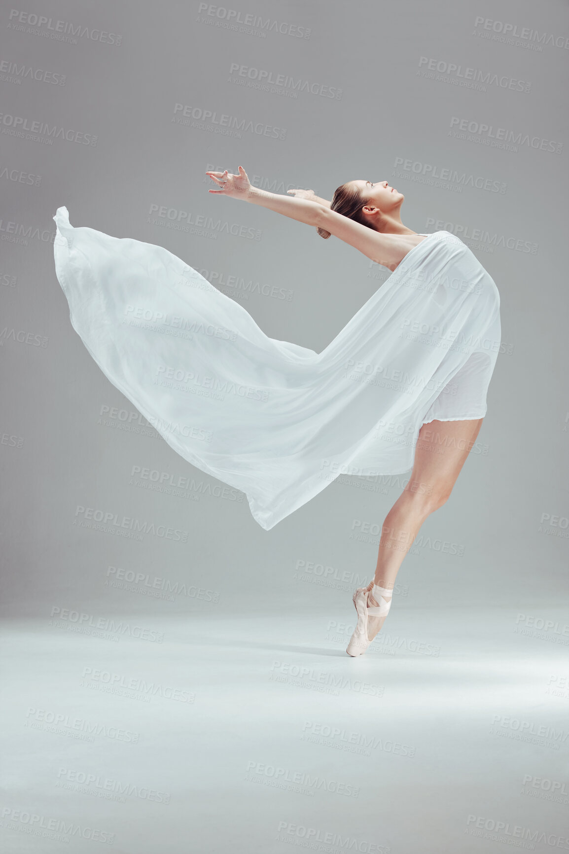 Buy stock photo Full length shot of an attractive young ballerina dancing alone in the studio