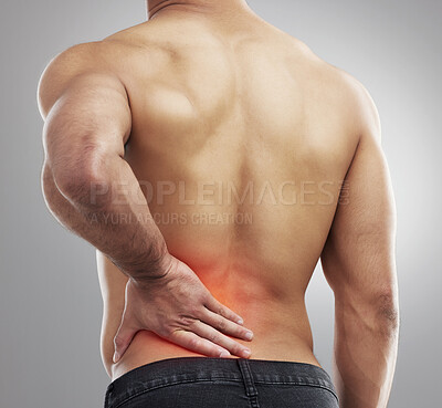 Buy stock photo Studio shot of a muscular unrecognizable man experiencing backache against a grey background