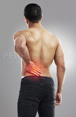 Buy stock photo Studio shot of a muscular unrecognizable man experiencing backache against a grey background