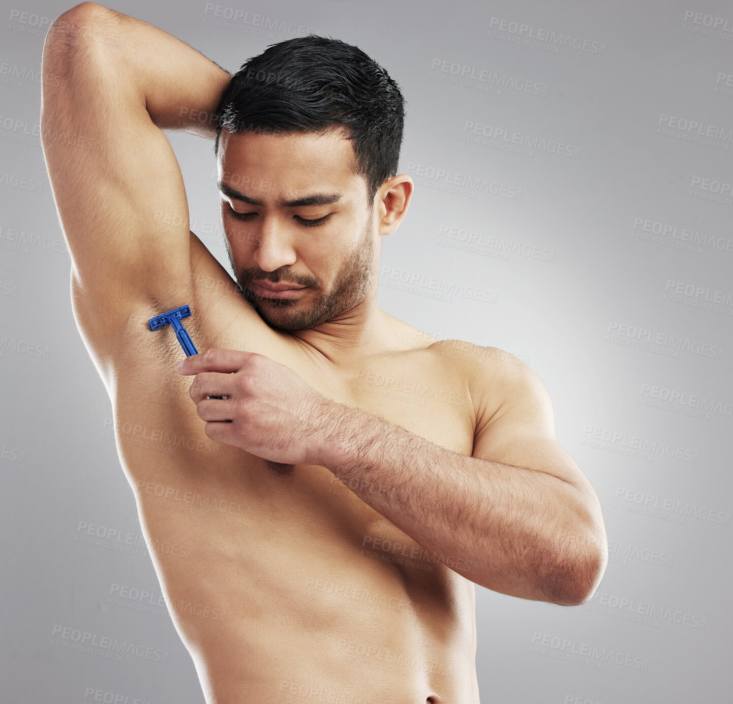 Buy stock photo Man, armpit and shaving razor for hair removal treatment or hygiene, grey background or studio. Asian person, tool and underarm cleaning or grooming with strong muscle or health, self care or routine