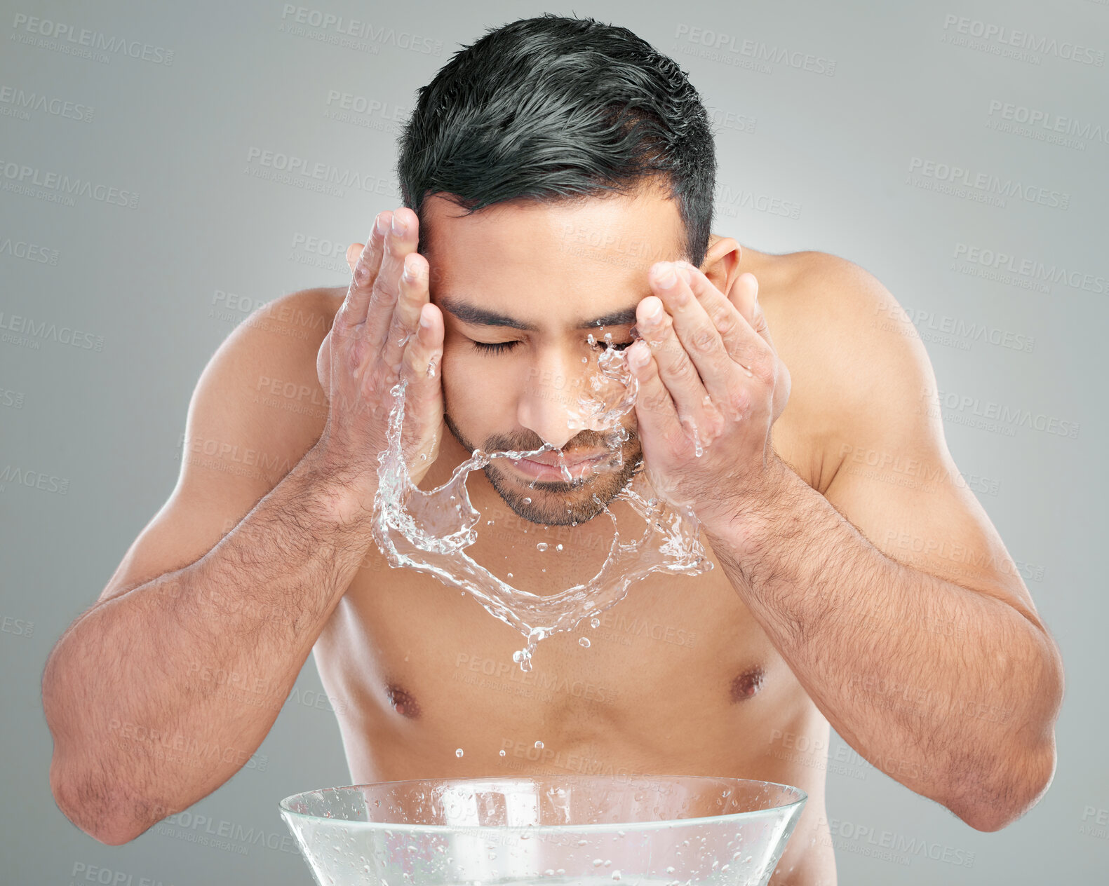 Buy stock photo Face wash, man and water splash in studio for skin care, hygiene or cleansing on gray background. Basin, hydration or male person with facial for grooming, dermatology or morning routine for cleaning