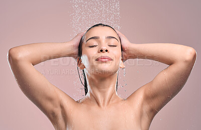 Buy stock photo Woman, hair and shower in studio with water, pink background and relaxing for cleaning or model washing. Grooming, hygiene and female person wet for self care, eyes closed and wellness routine