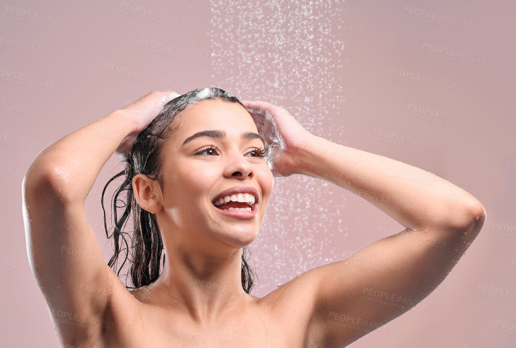 Buy stock photo Woman, hair and shower or wash in studio, pink background and relaxing for cleaning or model with water. Grooming, hygiene and female person wet for self care, happy and smile and wellness routine