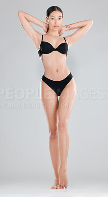 Buy stock photo Full length shot of an attractive young woman standing and posing in her underwear in the studio