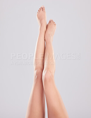 Buy stock photo Cropped shot of an unrecognisable woman showing her legs while posing in the studio
