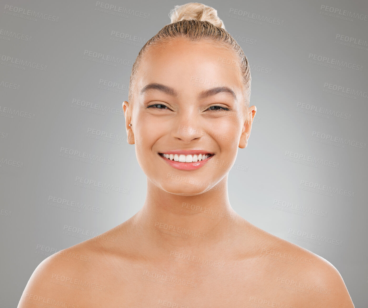 Buy stock photo Shot of an attractive young woman posing against a studio background