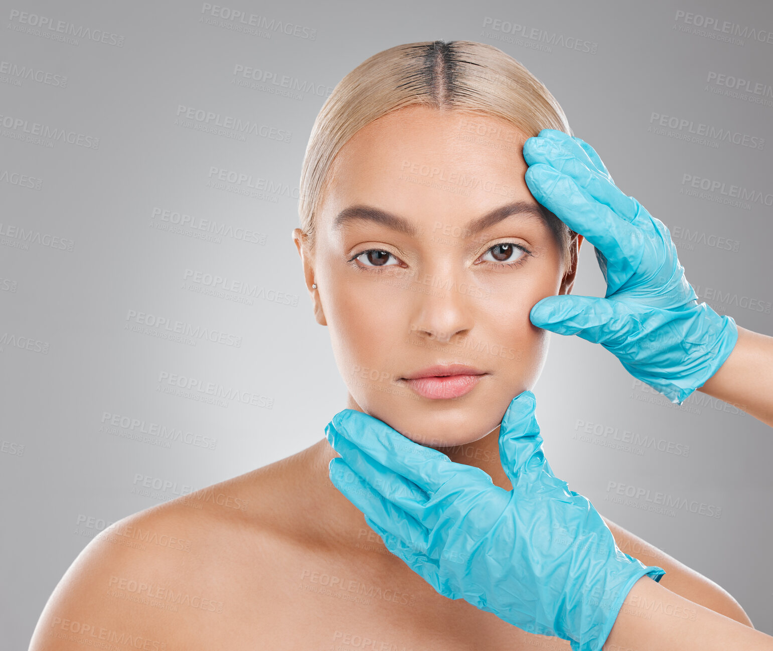 Buy stock photo Studio, hands and woman for skincare and face, gloves and plastic surgery on gray background. Beauty, cosmetic or medical treatment for selfcare, filler or collagen for portrait person for anti aging