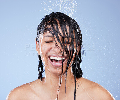 Buy stock photo Shot of a young woman washing her hair in the shower against a blue background