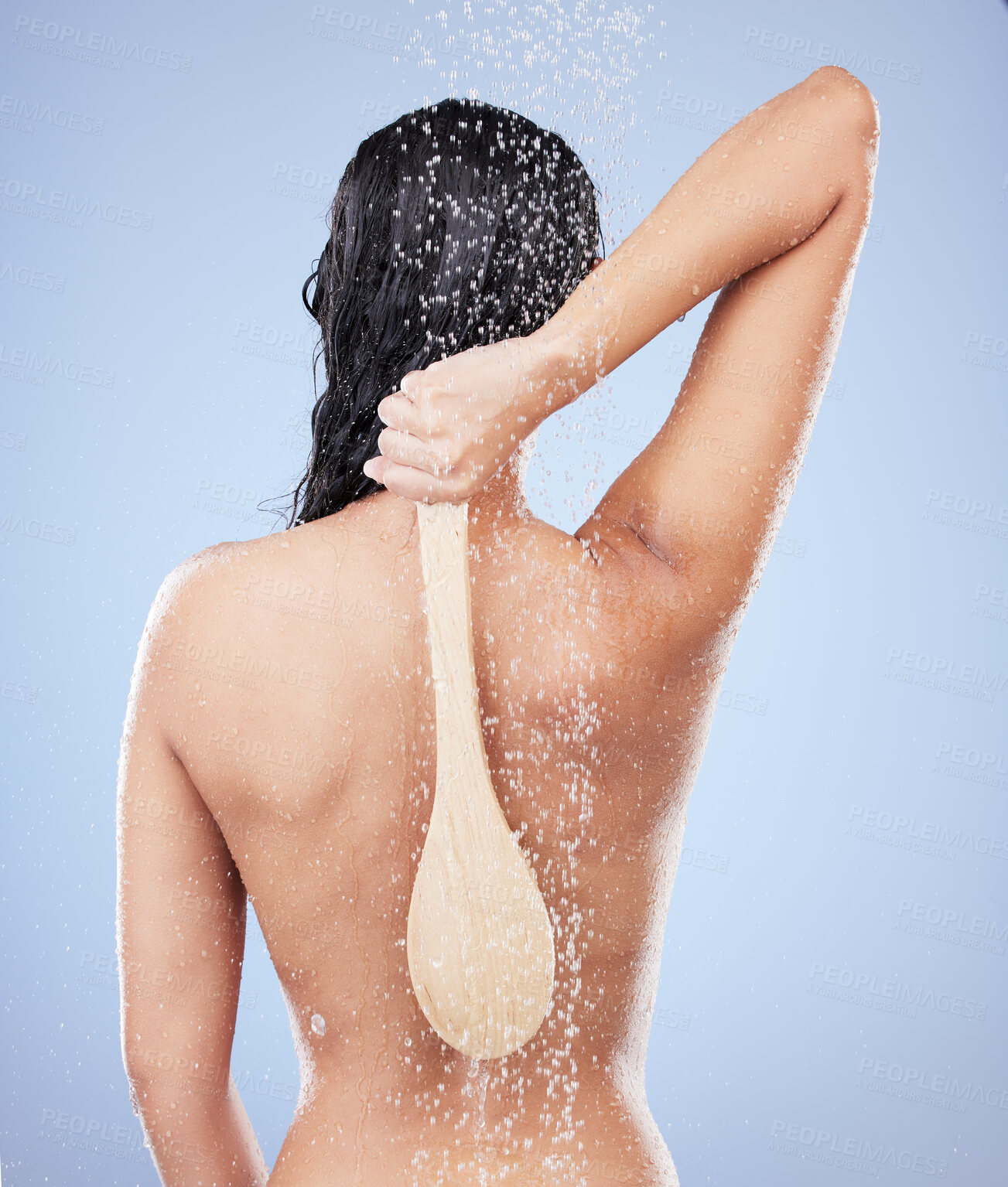Buy stock photo Shot of an unrecognizable woman taking a shower against a blue background