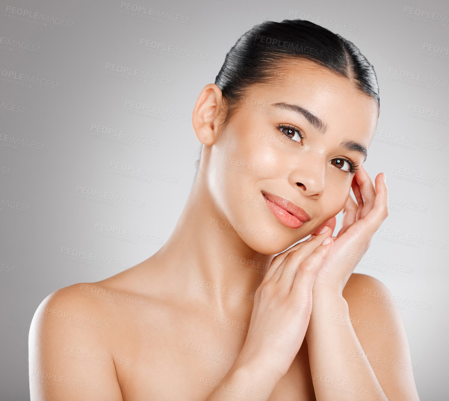 Buy stock photo Studio shot of an attractive young woman posing against a grey background