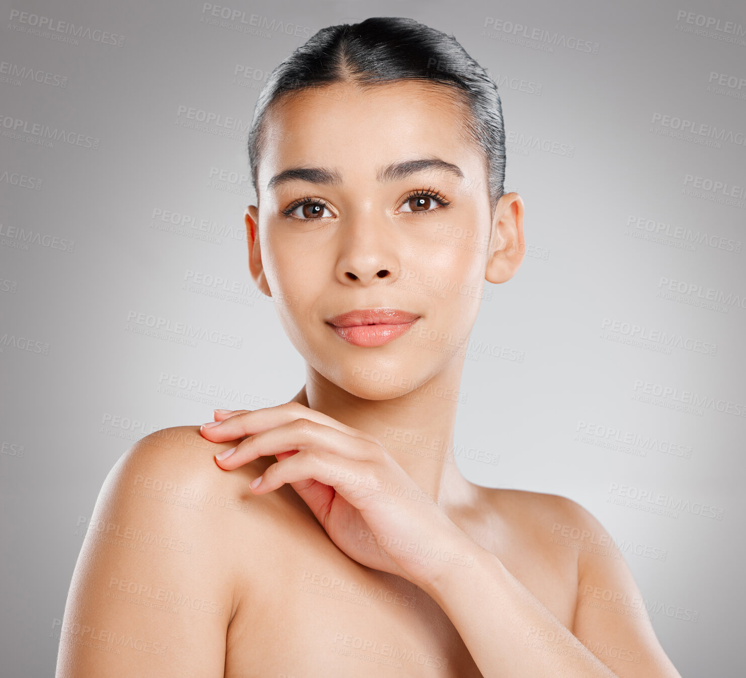 Buy stock photo Studio shot of an attractive young woman posing against a grey background