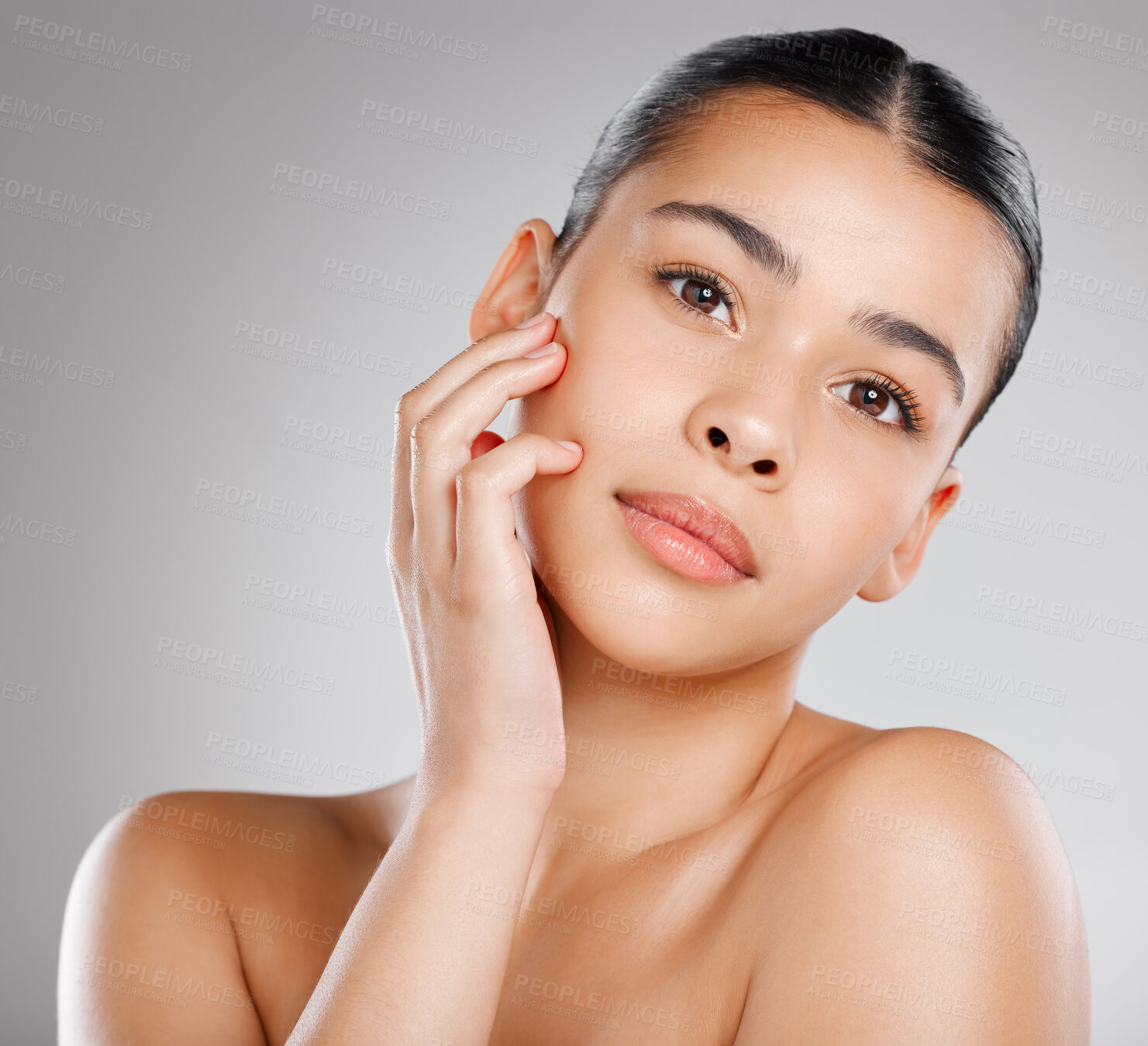 Buy stock photo Studio shot of an attractive young woman posing against a grey background