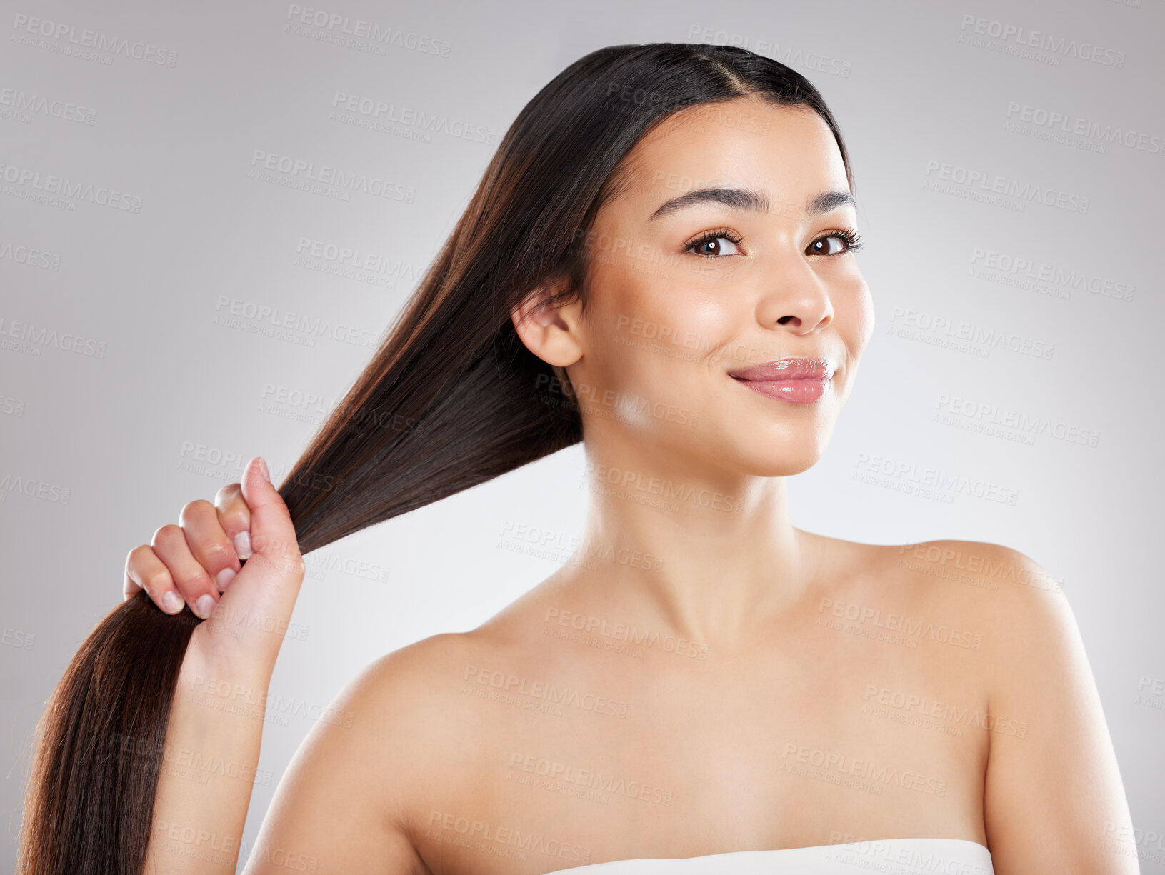 Buy stock photo Strong hair, pull or woman with portrait, smile or pride for confidence, results or keratin treatment. Healthy, happy or girl model in studio on grey background for wellness, natural growth or beauty